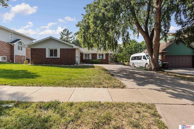 ranch-style home with a front yard and a garage