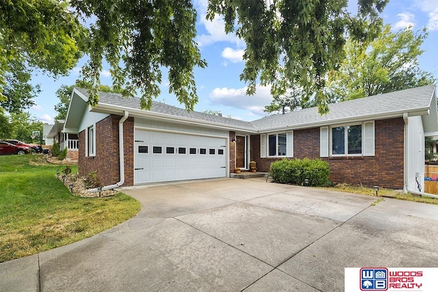 ranch-style home with a garage and a front lawn