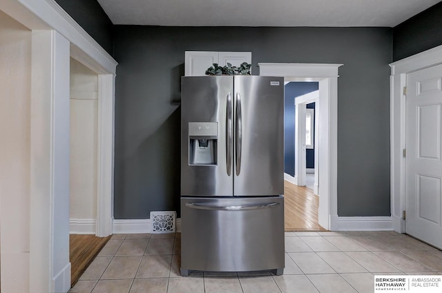 kitchen featuring stainless steel refrigerator with ice dispenser and light hardwood / wood-style flooring