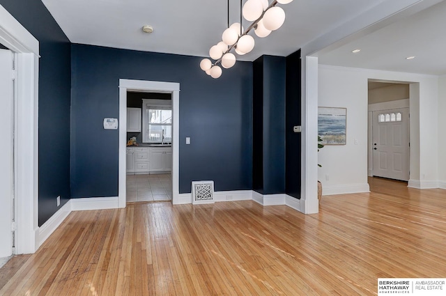 unfurnished dining area featuring light wood-type flooring