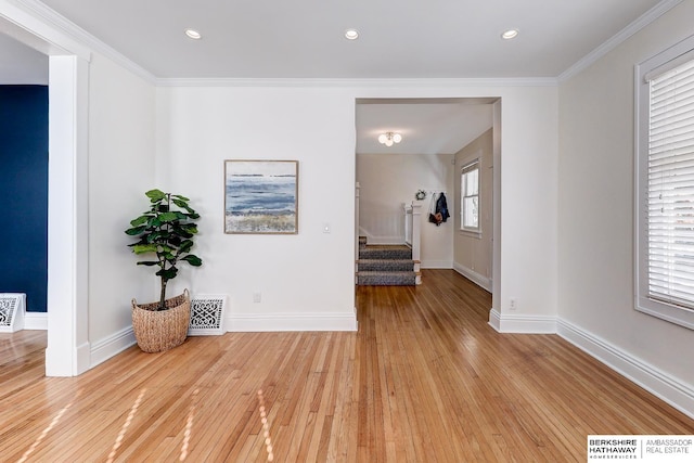 corridor with light hardwood / wood-style flooring and a healthy amount of sunlight