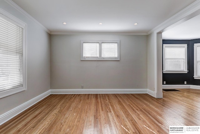 unfurnished room with light hardwood / wood-style floors and crown molding