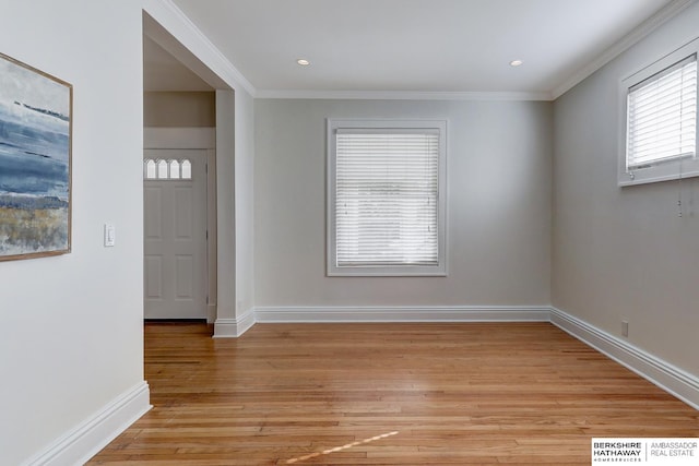 foyer featuring ornamental molding and light wood-type flooring