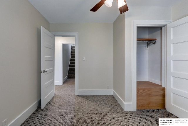 unfurnished bedroom with ceiling fan, a closet, and carpet floors