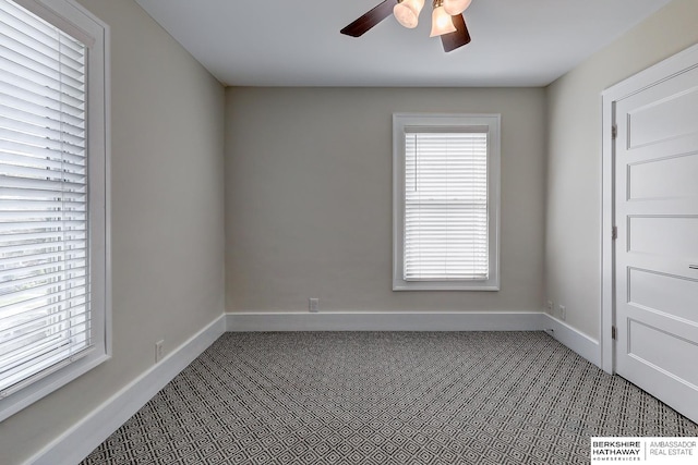 carpeted spare room featuring ceiling fan