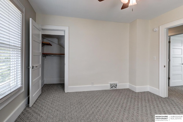 unfurnished bedroom featuring ceiling fan, carpet floors, and a closet