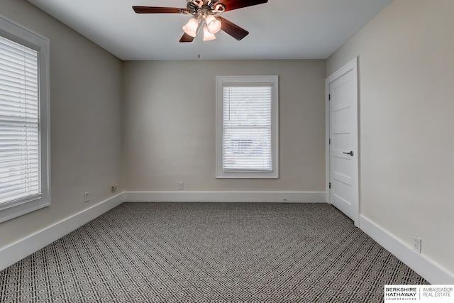 carpeted spare room featuring ceiling fan