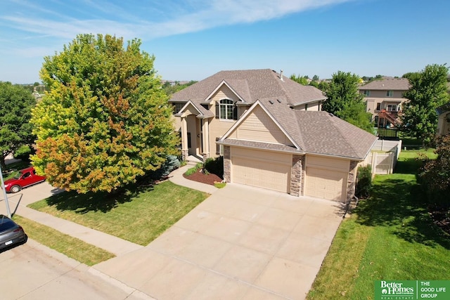 view of front of property with a front yard and a garage