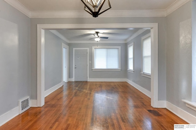 interior space with ceiling fan, dark hardwood / wood-style flooring, and ornamental molding