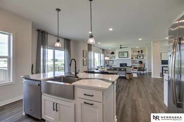 kitchen featuring white cabinets, stainless steel appliances, a healthy amount of sunlight, and sink