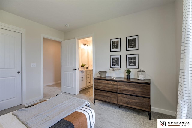 carpeted bedroom with ensuite bath