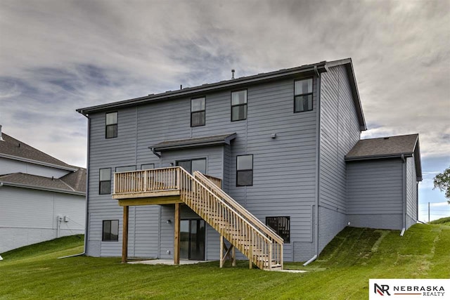 rear view of property with a lawn and a deck