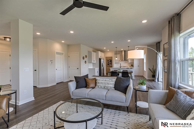 living room with hardwood / wood-style floors and ceiling fan