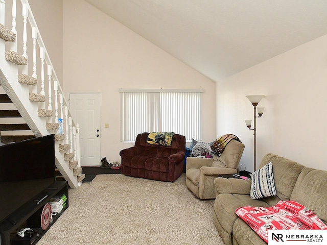 living room featuring carpet floors and high vaulted ceiling