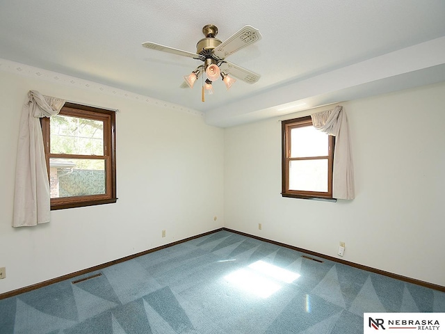 empty room with ceiling fan and carpet floors