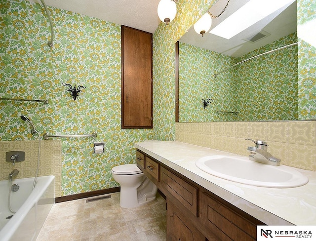 full bathroom featuring toilet, bathing tub / shower combination, and vanity