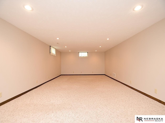 basement featuring light colored carpet