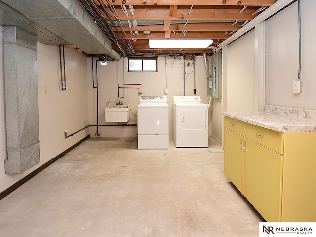 basement with washer and dryer, sink, and electric panel