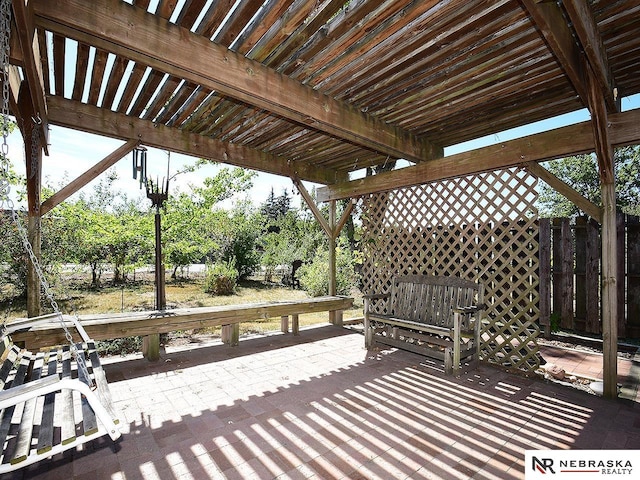 wooden deck with a patio and a pergola