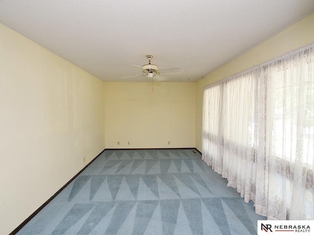 carpeted empty room with ceiling fan