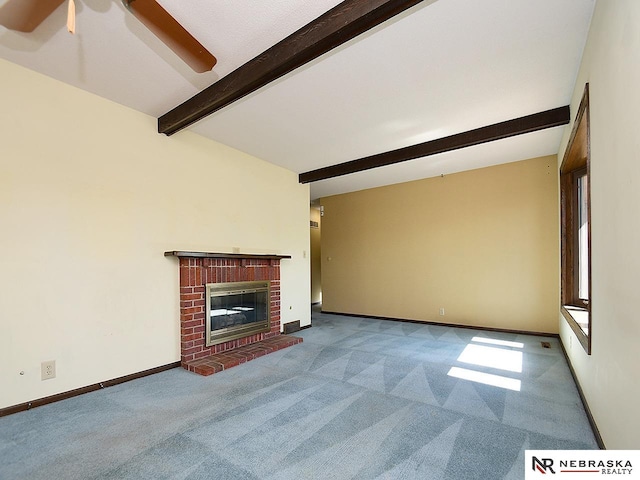 unfurnished living room with a brick fireplace, ceiling fan, light carpet, and beamed ceiling