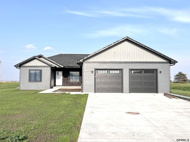 view of front facade with a front yard and a garage