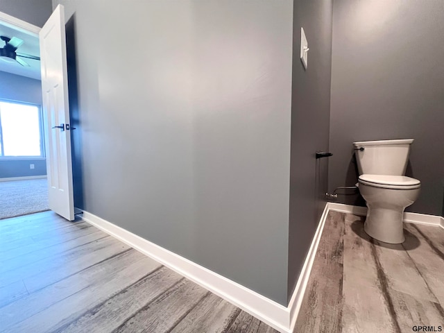 bathroom featuring hardwood / wood-style flooring and toilet