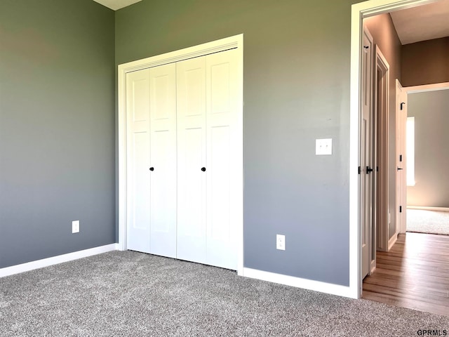 unfurnished bedroom featuring carpet flooring and a closet