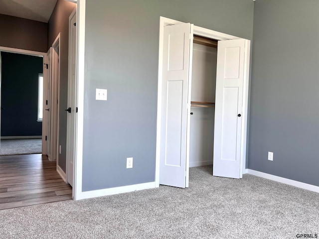 unfurnished bedroom featuring a closet and wood-type flooring