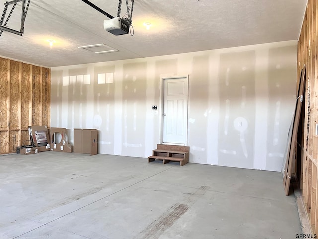 garage featuring wood walls and a garage door opener