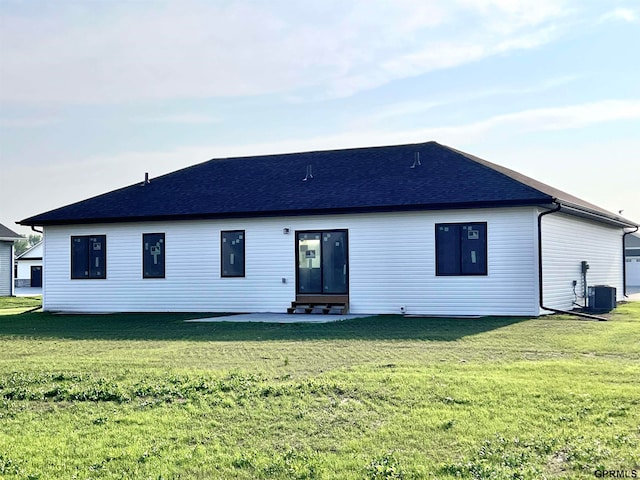 rear view of house featuring a yard, central AC, and a patio area