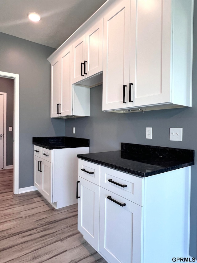 kitchen featuring white cabinets and light hardwood / wood-style floors