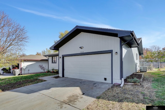 view of front of home with cooling unit and a garage