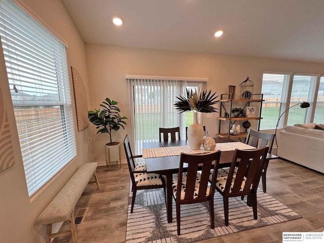 dining area with light wood-type flooring and a wealth of natural light