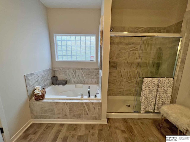 bathroom featuring separate shower and tub and wood-type flooring