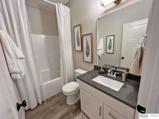 full bathroom featuring wood-type flooring, vanity, toilet, and shower / bathtub combination with curtain