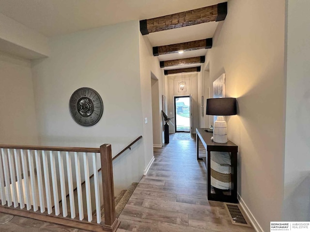 hallway featuring beam ceiling and wood-type flooring