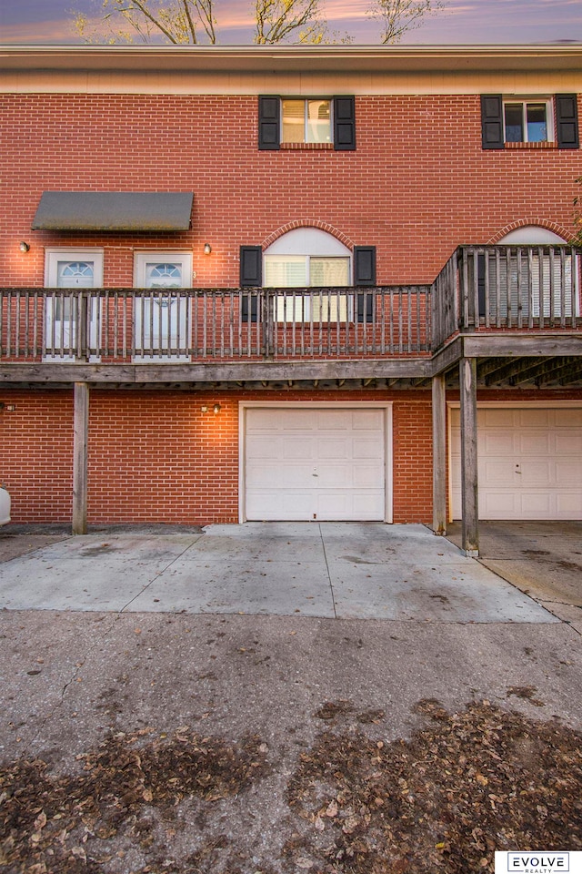 back house at dusk with a garage