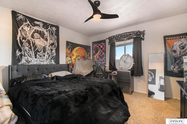 bedroom featuring carpet, a textured ceiling, and ceiling fan