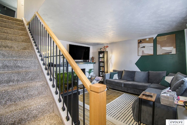 carpeted living room featuring a textured ceiling