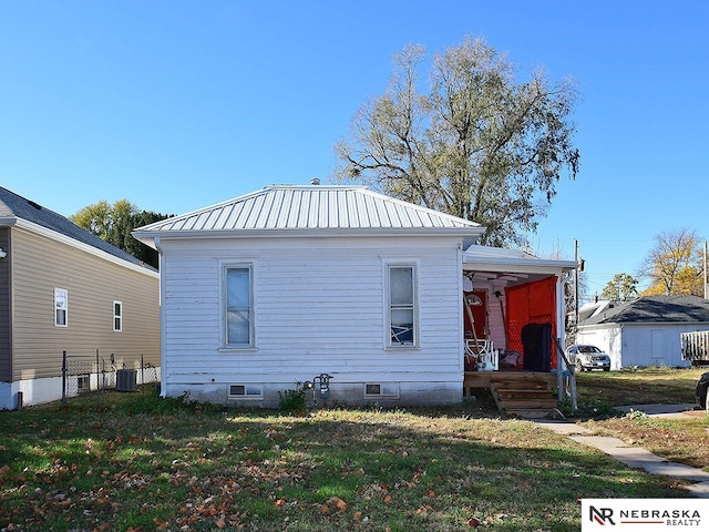 view of side of property with a lawn and central air condition unit