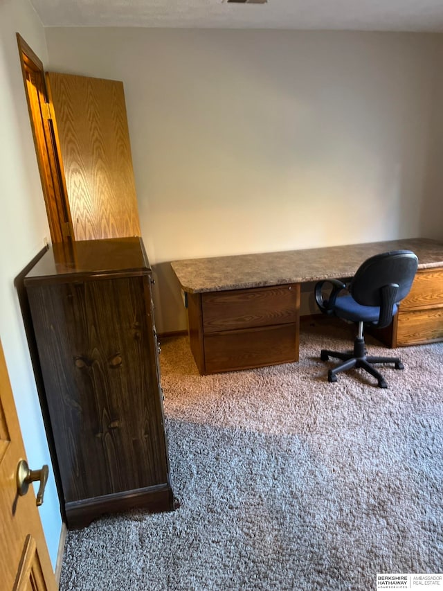 office space featuring carpet flooring and built in desk