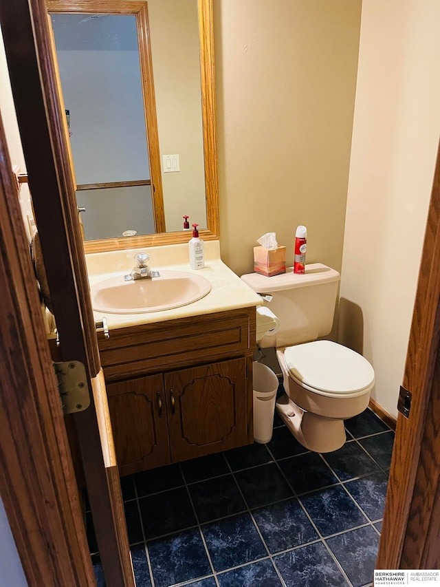 bathroom featuring tile patterned floors, vanity, and toilet