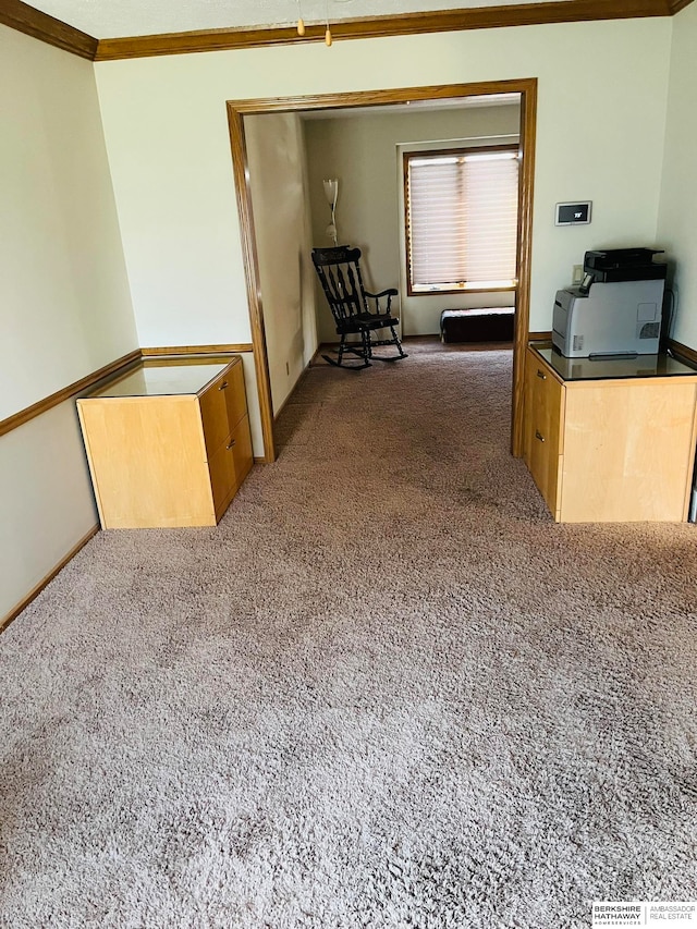 hallway featuring dark colored carpet and ornamental molding