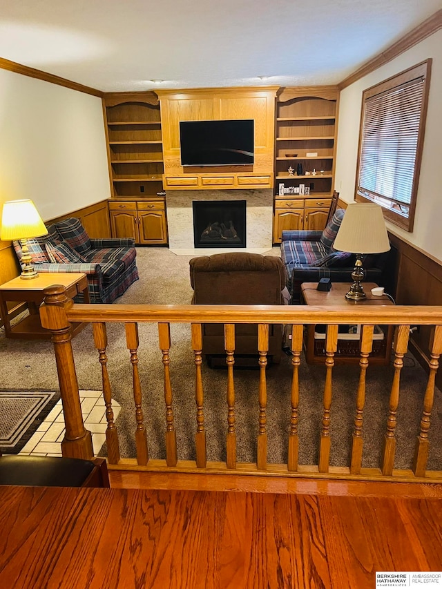 living room featuring wood walls and ornamental molding