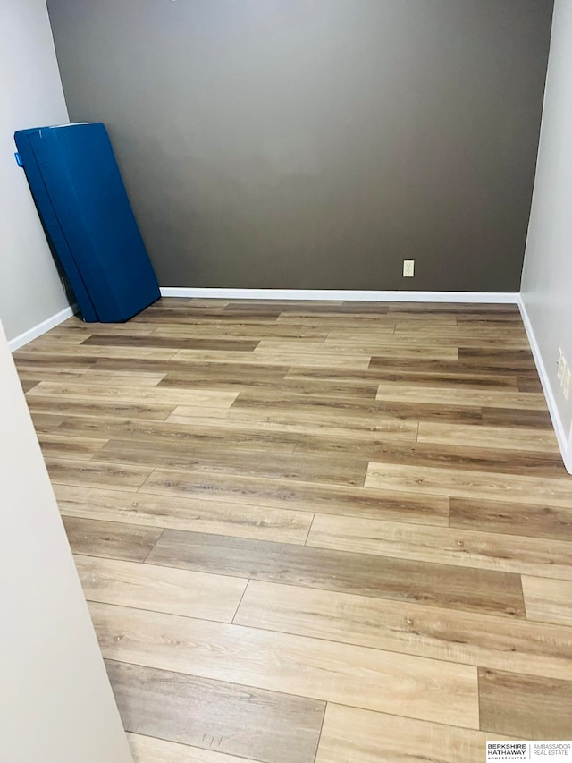 empty room with hardwood / wood-style flooring