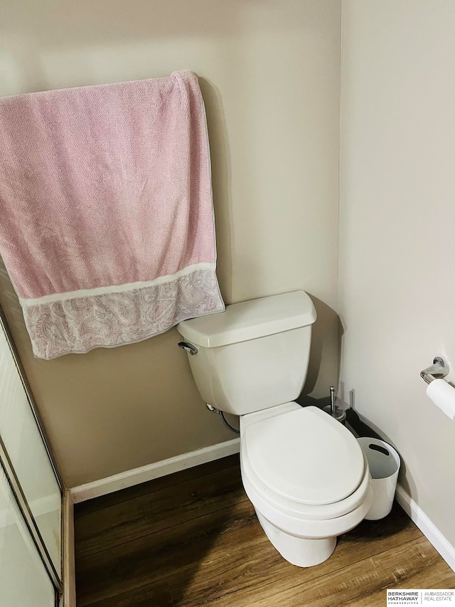 bathroom with wood-type flooring and toilet