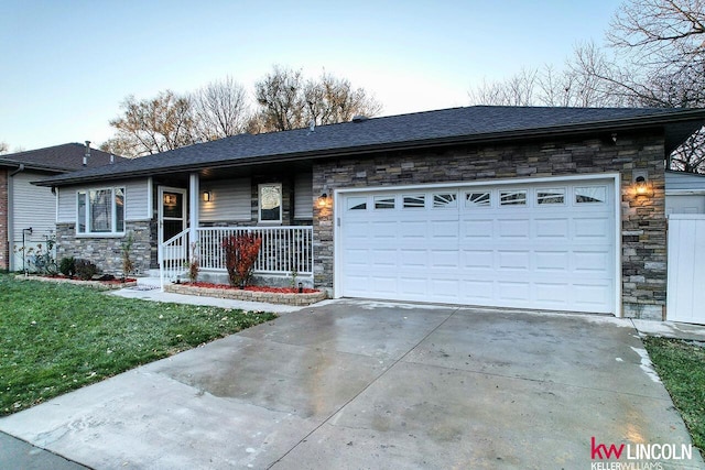 ranch-style house with covered porch and a garage