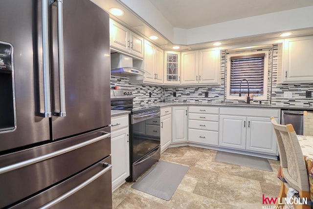 kitchen with white cabinets, backsplash, sink, and stainless steel appliances