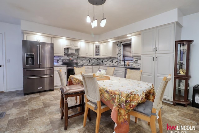 dining room featuring an inviting chandelier and sink